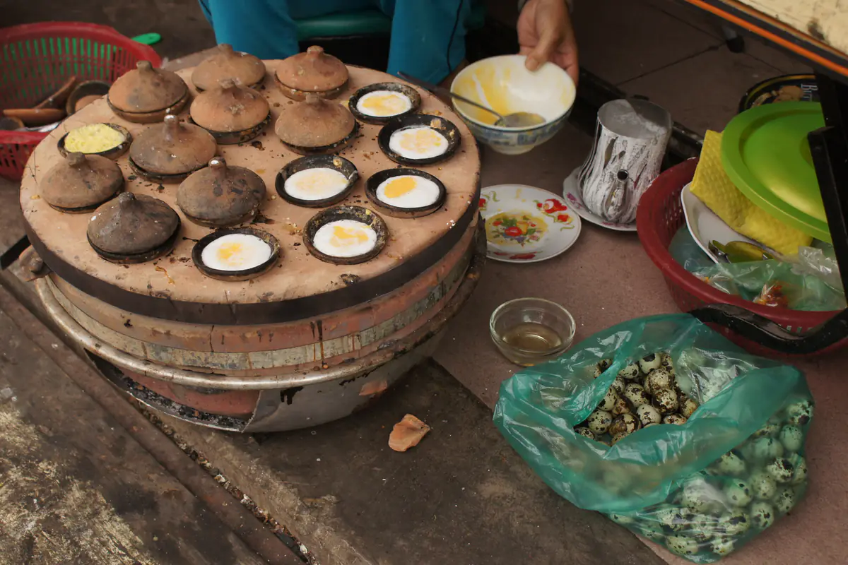 Khuôn đất nung nướng trứng cút, loại khuôn quen thuộc để đổ bánh căn, tại một khu chợ ở Đà Lạt