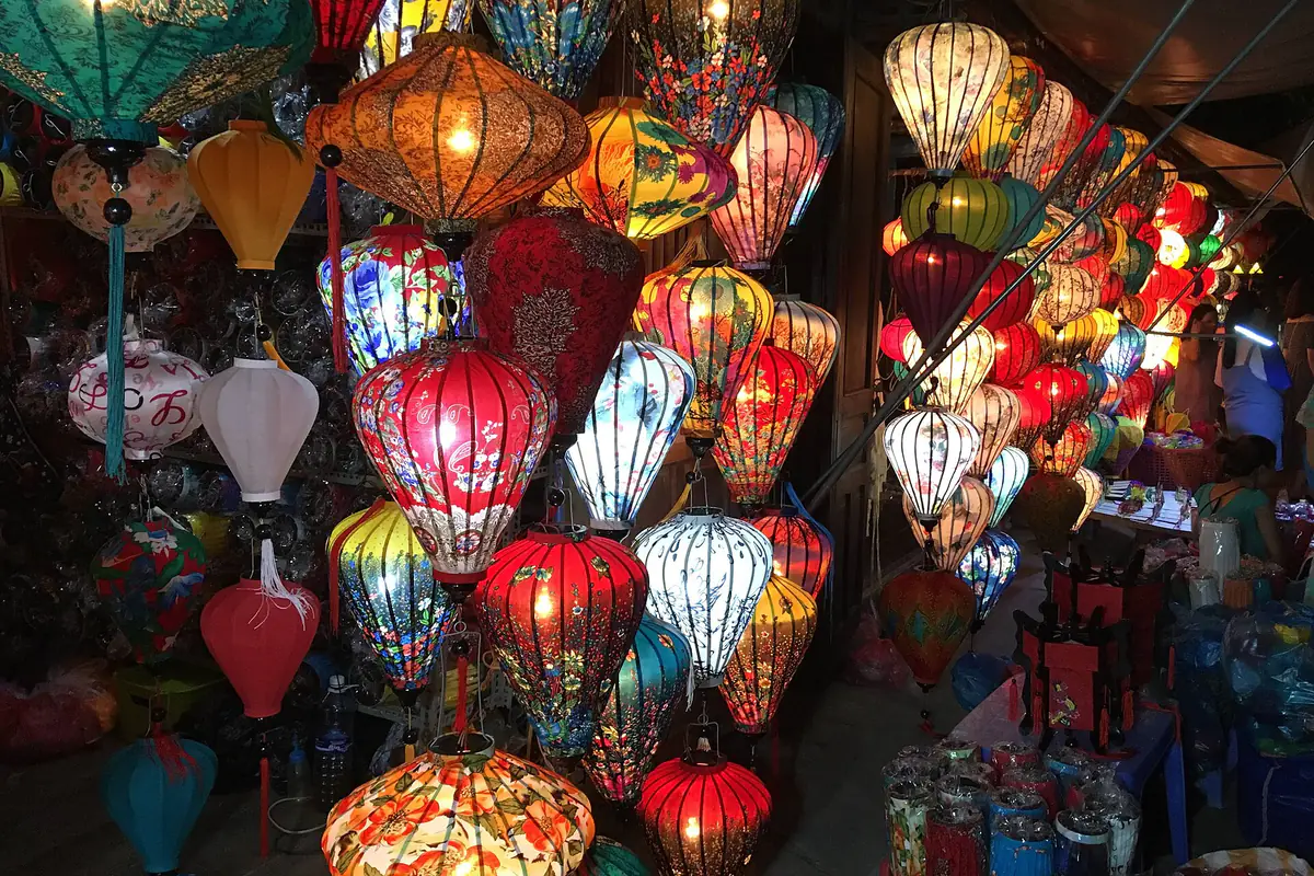 Một cửa hàng đèn lồng lụa ở Hội An treo kín đèn nhiều màu đỏ, vàng, xanh, trắng in hoa văn, thắp sáng trong đêm 14 tháng 6 âm lịch, tháng 7/2018